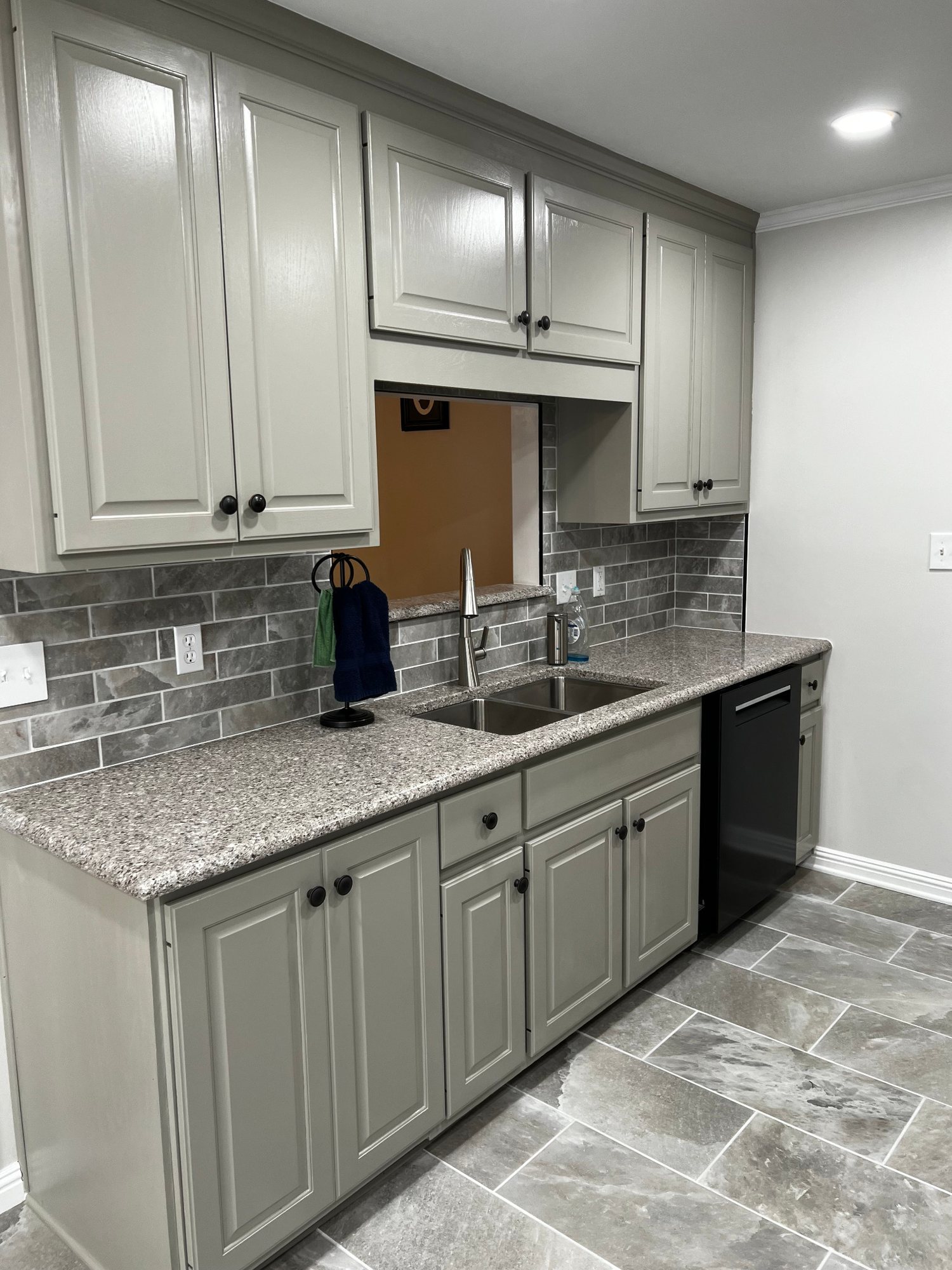 Finished kitchen renovation with new cabinets, tile, and flooring